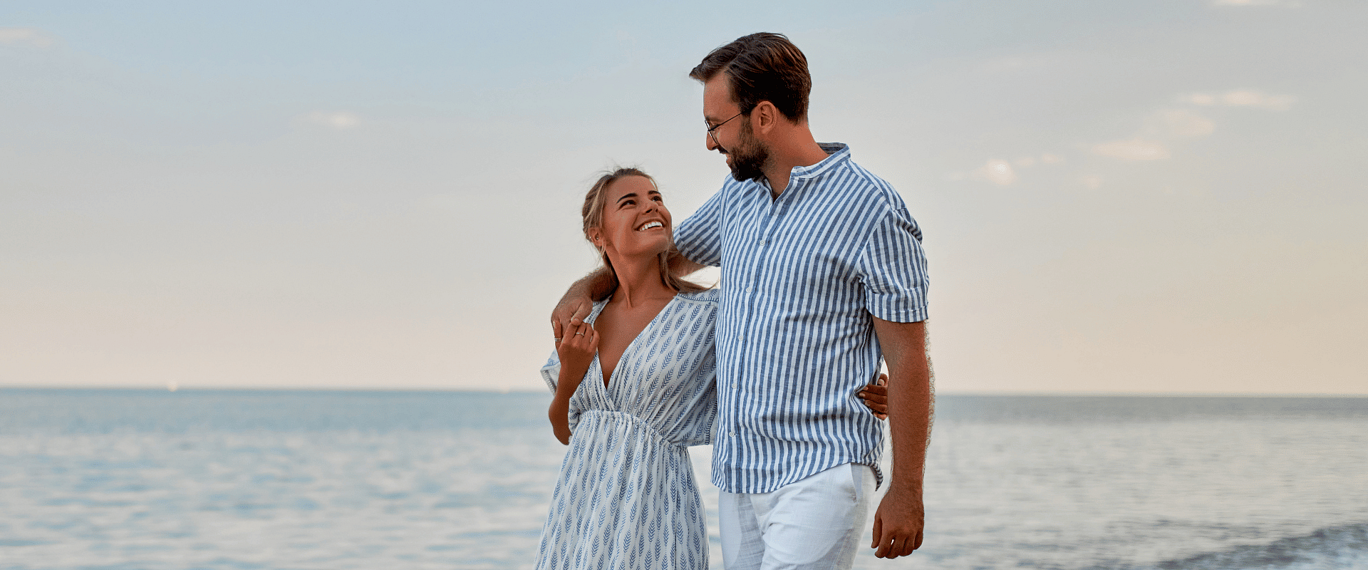 Stunning aerial view of a paradisiacal private island with turquoise waters, overwater bungalows, and white sand. Discover our 15% discount offer on all romantic plans
